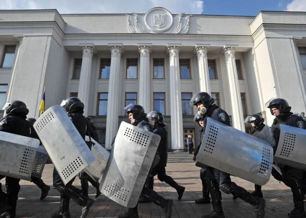 Police troops leave their position around Ukrainian Parliament in Kiev. Picture: AP