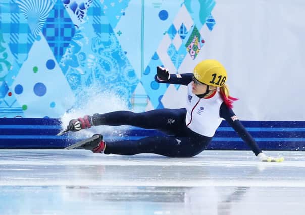 Elise Christie crashes to the floor after tangling with Li Jianrou. Picture: Getty