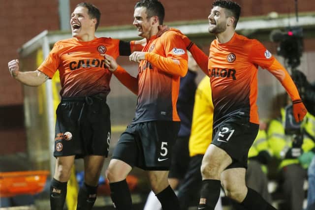 Dundee United's Gavin Gunning celebrates his 2nd goal with John Rankin (left) and Nadir Ciftci (right). Picture: PA