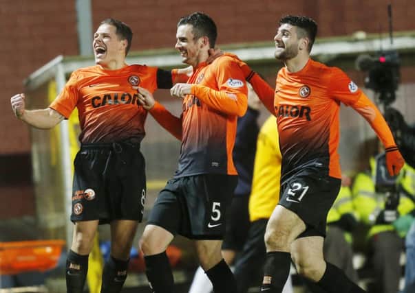 Dundee United's Gavin Gunning celebrates his 2nd goal with John Rankin (left) and Nadir Ciftci (right). Picture: PA