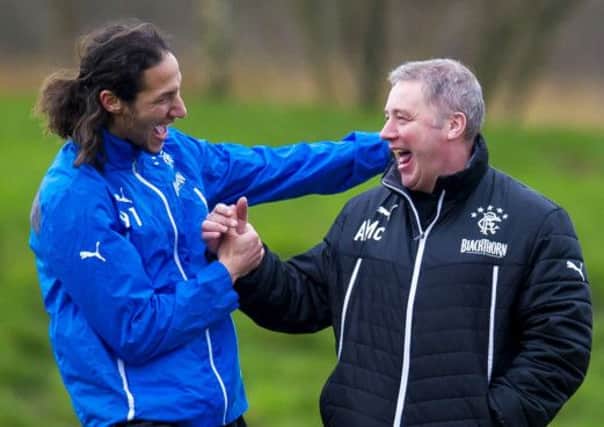 Ally McCoist shares a joke with Bilel Mohsni, left. McCoist isn't worried about Rangers' financial situation. Picture: SNS