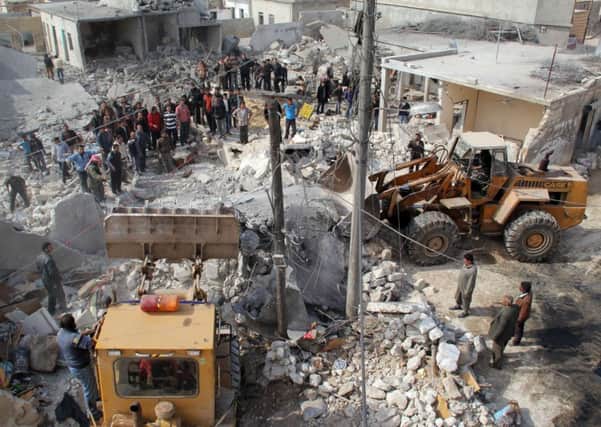 Rescue workers search for survivors following a reported air strike by government forces on the Syrian city of Aleppo. Picture: Getty