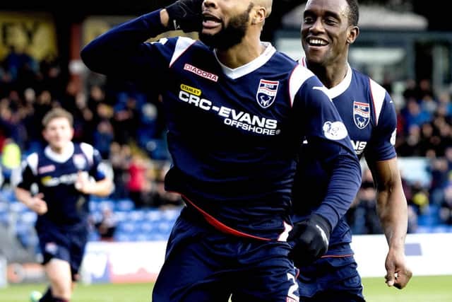 Ross Countys Yoann Arquin, left, wheels away to celebrate putting his side ahead. Picture: SNS