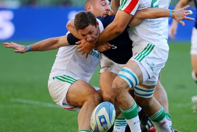 Chris Cusiter is well shackled here but he turned in an excellent display against Italy. Picture: PA