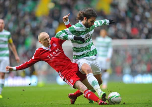 Willo Flood puts a strong challenge in on Celtic's Georgios Samaras. Picture: Robert Perry
