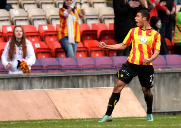 Lyle Taylor celebrates in front of the home fans after putting Partick 2 goals ahead. Picture: SNS