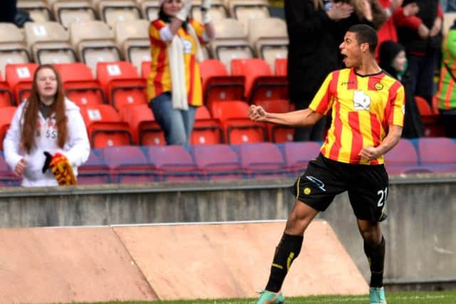 Lyle Taylor celebrates in front of the home fans after putting Partick 2 goals ahead. Picture: SNS