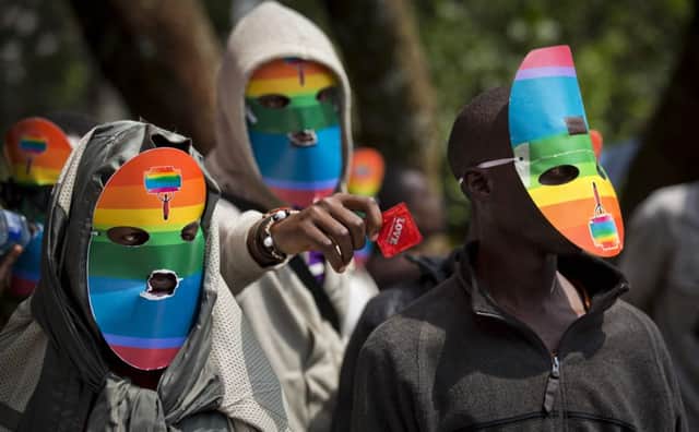 Lesbians and gays, wearing masks to preserve anonymity, protest outside in Nairobi, Kenya. Picture: AP