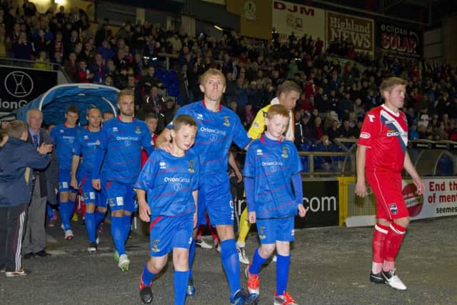 Richie Foran leads out his team alongside opposite number Richie Brittain. Picture: SNS