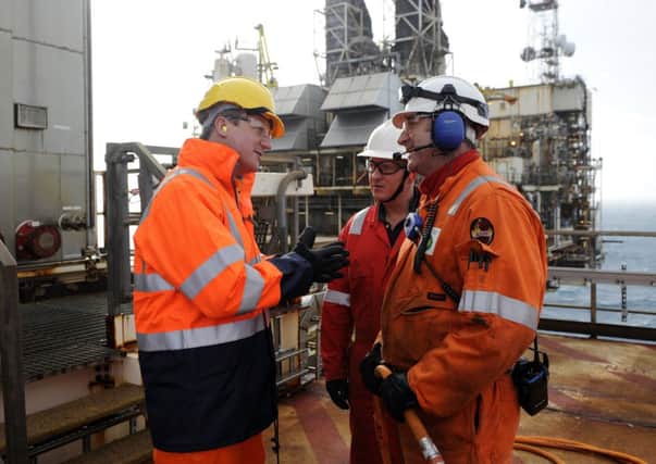 David Cameron talks with employees during a tour of the BP ETAP oil platform. Picture: Getty