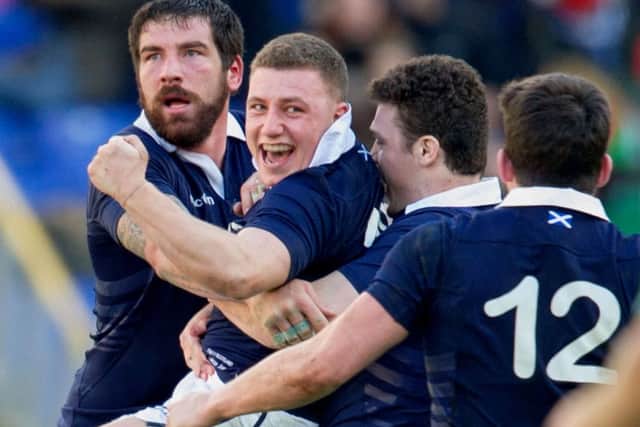 Duncan Weir is engulfed by his team-mates as they celebrate his drop goal. Picture: SNS/SRU