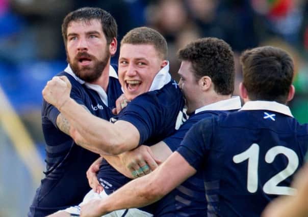 Duncan Weir is engulfed by his team-mates as they celebrate his drop goal. Picture: SNS/SRU