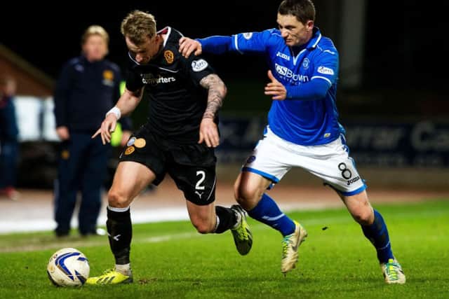 St Johnstone's Gary McDonald (right) holds back Craig Reid. Picture: SNS