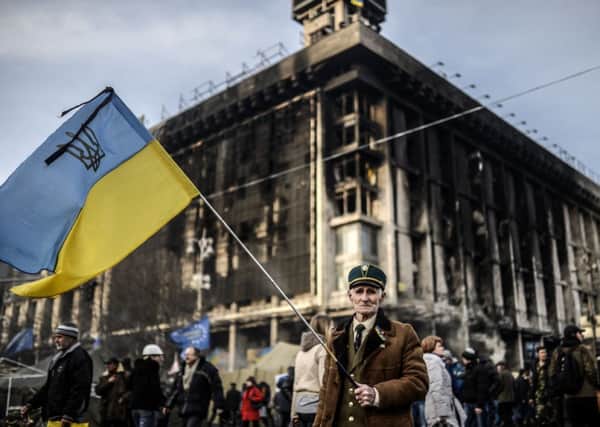 Man stands with a Ukrainian flag on Kiev's Independence square. Picture: Getty
