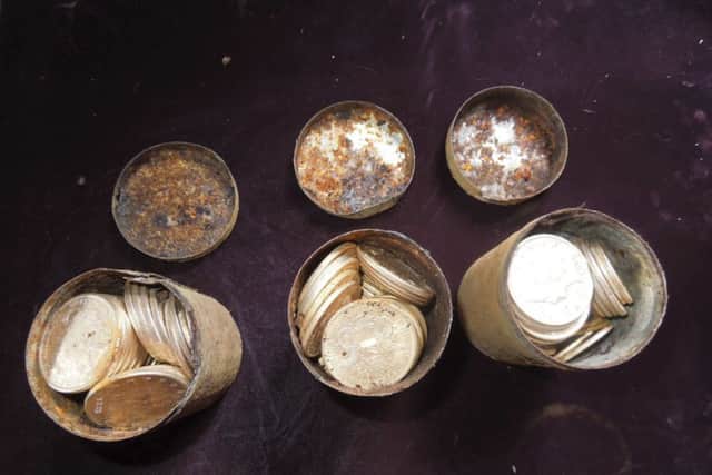Cans containing 19th century gold coins are shown. Picture: Reuters