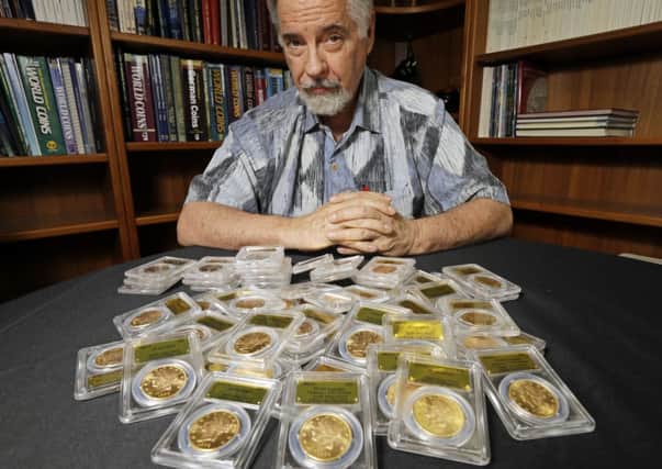 David Hall, co-founder of Professional Coin Grading Service, poses with some of 1,427 Gold-Rush era US gold coins. Picture: AP
