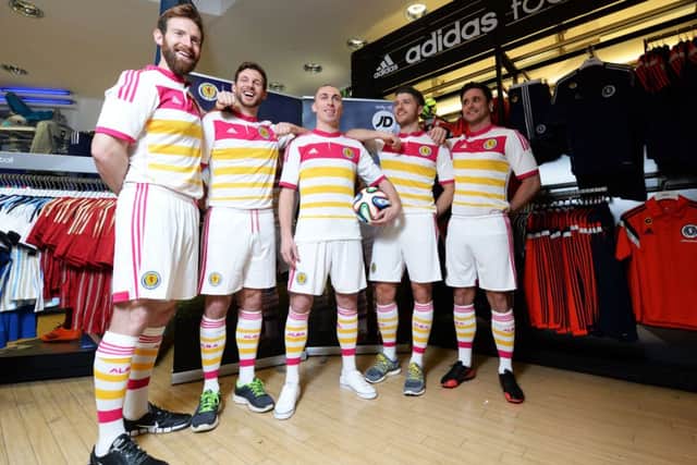 Scott Brown poses with his fellow models in the new Scotland away strip. Picture: SNS