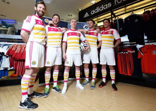 Scott Brown poses with his fellow models in the new Scotland away strip. Picture: SNS
