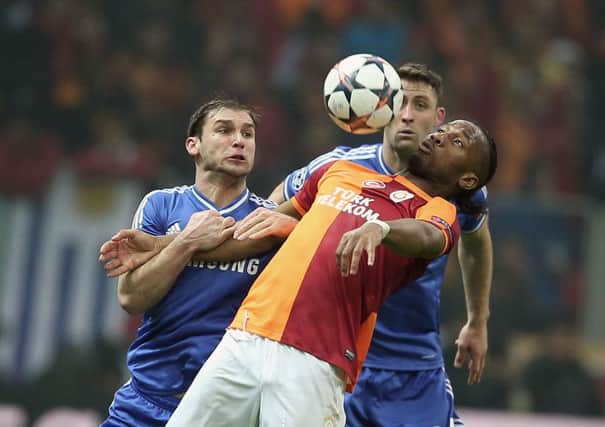 Didier Drogba of Galatasaray, front, and Branislav Ivanovic of Chelsea fight for the ball. Picture: AP