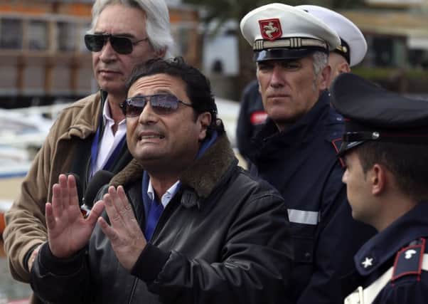 Francesco Schettino, centre, goes back to the Costa Concordia. Picture: Reuters