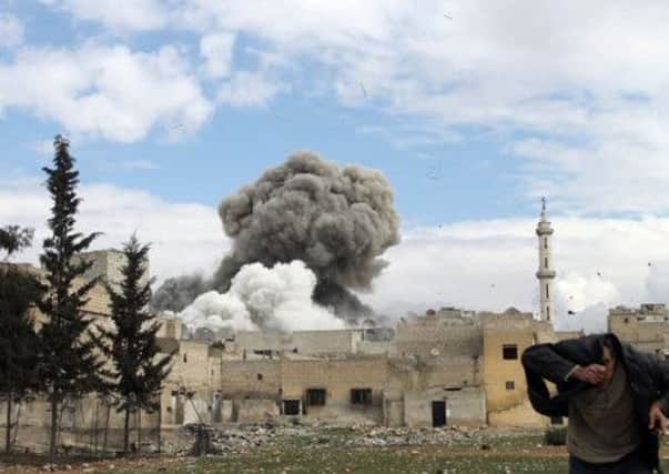 A man runs for cover following a reported bombing in the northern city of Aleppo. Picture: Getty Images