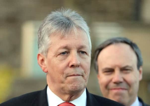 Peter Robinson confirmed at a press conference that he was withdrawing his threat to resign. Picture: AP