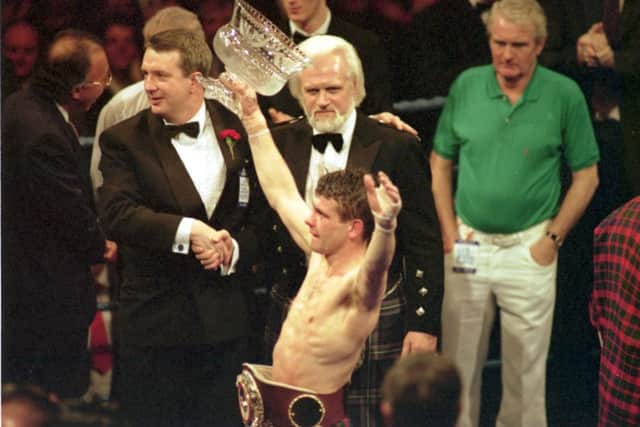 Pat Clinton celebrates with his world flyweight championship belt at the Kelvin Hall. Picture: Jeff Mitchell