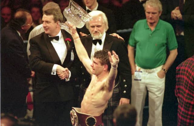 Pat Clinton celebrates with his world flyweight championship belt at the Kelvin Hall. Picture: Jeff Mitchell