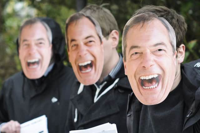 Delegates outside the Ukip conference in Torquay yesterday wear masks of Nigel Farage. Picture: PA