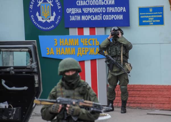 Troops in unmarked uniforms stand guard as they take control of the Coast Guard offices on the outskirts of Sevastopol. Picture: AP