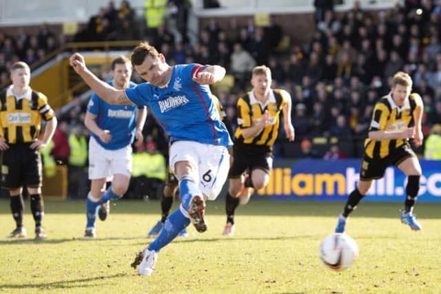 Lee McCulloch tucks away an injury time penalty to give Rangers a barely-deserved three points. Picture: SNS