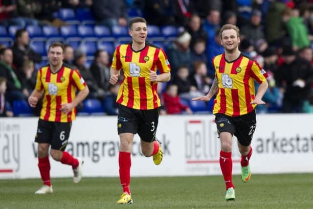 Kallum Higginbotham (right) celebrates his opening goal for Partick Thistle. Picture: SNS