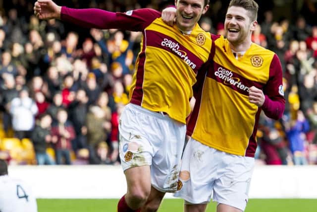 Motherwell's John Sutton (2nd from right) joins fellow scorer Iain Vigurs as he celebrates scoring his side's third. Picture: SNS
