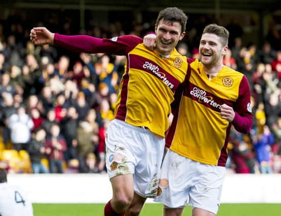 Motherwell's John Sutton (2nd from right) joins fellow scorer Iain Vigurs as he celebrates scoring his side's third. Picture: SNS
