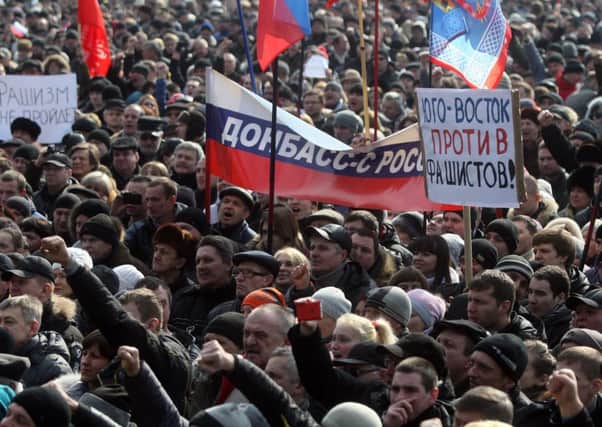 Pro-Russian protesters hold a banner reading "Donetsk region with Russia" at a rally in the city. Picture: Getty