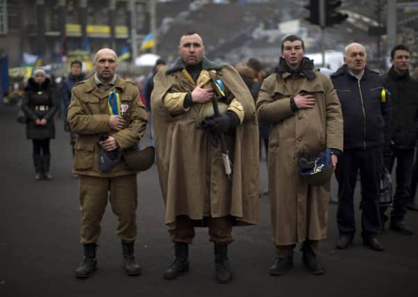 Anti-Yanukovych protesters sing Ukraine's national anthem in Kiev's Independence Square. Picture: AP