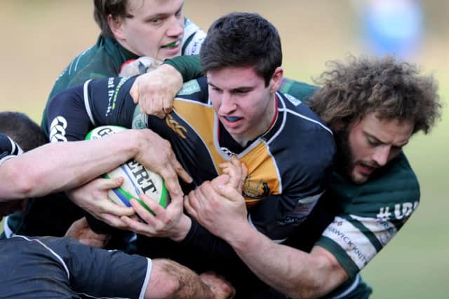 Currie's Ruaridh Smith hits a wall of Hawick tacklers. Picture: Jane Barlow