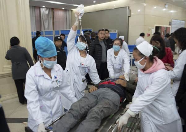 An injured man is pushed at a hospital after a knife attack at Kunming railway station, Yunnan province. Picture: Reuters