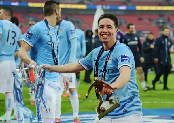 Samir Nasri celebrates with the Capital One Cup. Picture: Getty