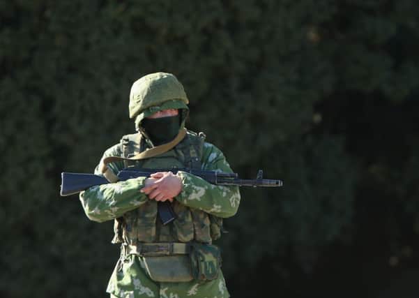 Troops displaying no insignia stand guard outside a local government building in Ukraine. Picture: Getty