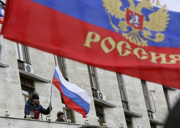 Pro-Moscow demonstrators with a Russian flag outside a government building in Donetsk. Picture: Reuters