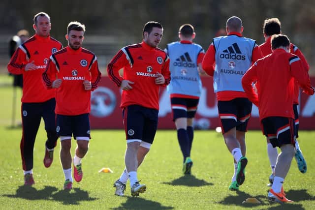 Ross McCormack, centre, limbers up ahead of James Morrison and Charlie Adam during yesterdays Scotland training session at Murray Park. Picture: PA