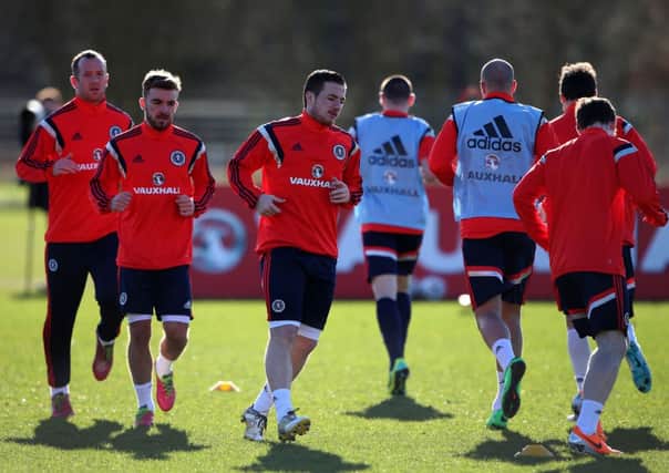 Ross McCormack, centre, limbers up ahead of James Morrison and Charlie Adam during yesterdays Scotland training session at Murray Park. Picture: PA