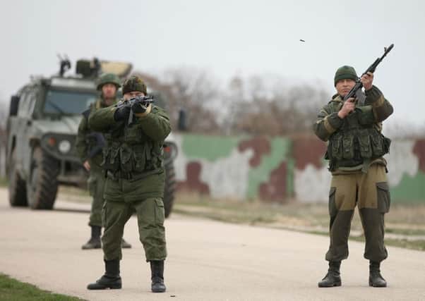 Soldiers under Russian command fire weapons into the air near Ukrainian troops at the Belbek airbase, which the Russians are occcupying in Lubimovka, Ukraine. Picture: Sean Gallup/Getty Images