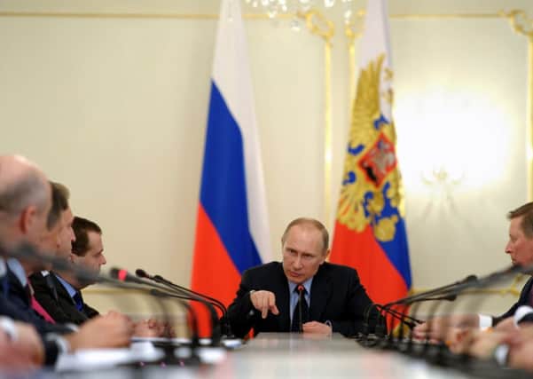 Russian president Vladimir Putin chairs a government meeting over the Ukraine crisis yesterday. Picture: AFP/Getty