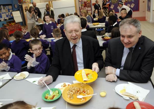 Education secretary Mike Russell and rural affairs secretary Richard Lochhead launch the new guidance on school meals with a visit to Strathesk Primary Schools canteen in Penicuik yesterday. Picture: Greg Macvean