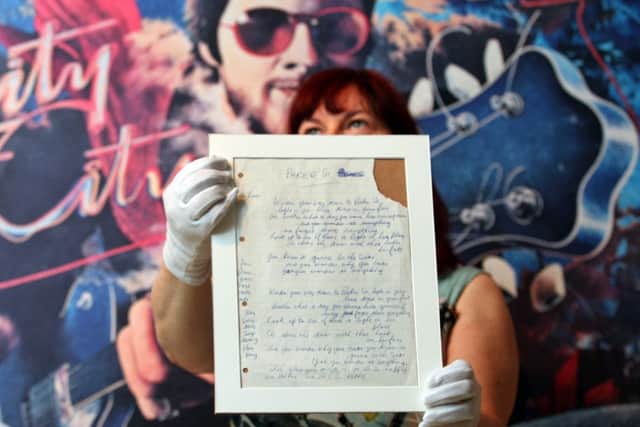 Paisley Museum curator Andrea Kusel holds the hand written lyrics to Gerry Raffertys hit song Baker Street. Picture: Hemedia