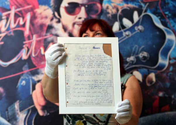 Paisley Museum curator Andrea Kusel holds the hand written lyrics to Gerry Raffertys hit song Baker Street. Picture: Hemedia