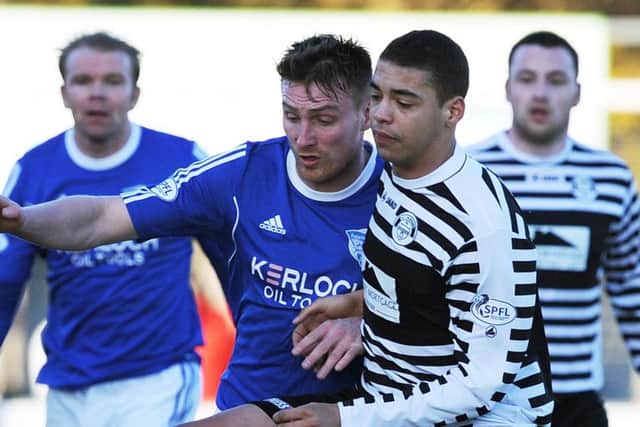 Jordan Tapping, right, tackles Rory McAllister of Peterhead. Tapping was later taken off after being racially abused. Picture: Duncan Brown