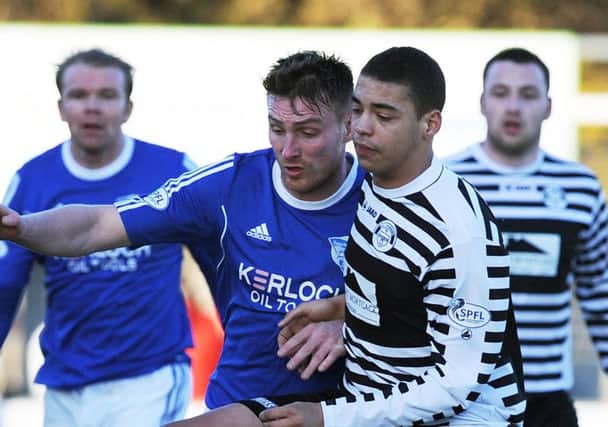 Jordan Tapping, right, tackles Rory McAllister of Peterhead. Tapping was later taken off after being racially abused. Picture: Duncan Brown